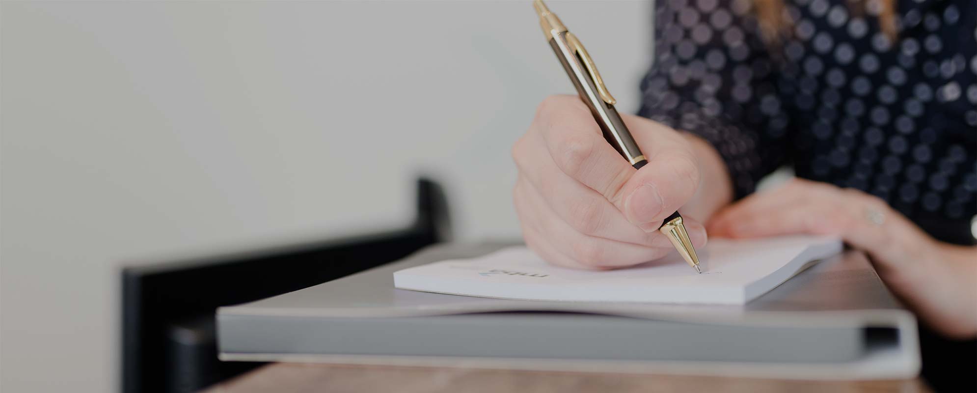 Woman Holding Pen Writing on Paper