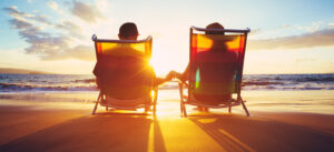 Couple on a beach looking at the sunset